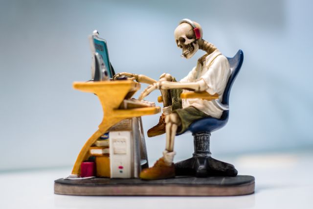 Skeleton working on a computer
